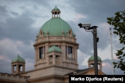A surveillance camera is seen in front of the Serbian Parliament building in Belgrade.
