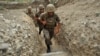 Nagorno-Karabakh -- Armenian soldiers of the self-proclaimed republic of Nagorno-Karabagh walk in a trench at the frontline on the border with Azerbaijan near the town of Martakert, 06Jul2012