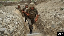 Nagorno-Karabakh -- Armenian soldiers of the self-proclaimed republic of Nagorno-Karabagh walk in a trench at the frontline on the border with Azerbaijan near the town of Martakert, 06Jul2012