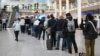 Passengers wait in line for new plane tickets at Copenhagen Airport on September 23, a day after unidentified drones disrupted flights at the aviation hub. 