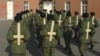 Солдаты тренируют военную выправку, используя деревянные кресты