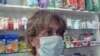 Armenia -- Employee of a drugstore in Yerevan wears a mask, Yerevan, 10Nov2009